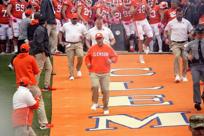 Dabo Swinney running down the hill at Clemson before a matchup with Florida State
